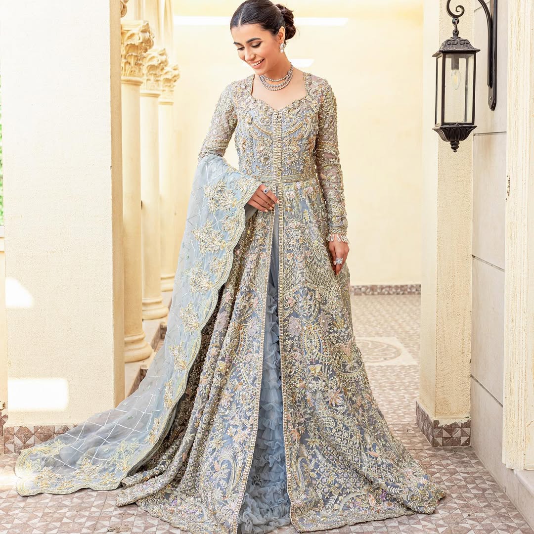 Pieta luxury Pakistani bridal outfit in ice blue organza with delicate embroidery and gold detailing.