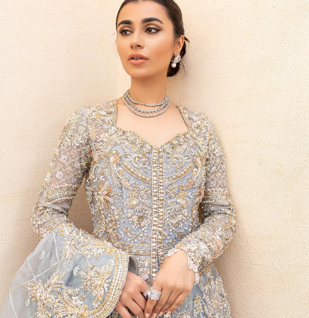 Pieta luxury Pakistani bridal outfit in ice blue organza with delicate embroidery and gold detailing.
