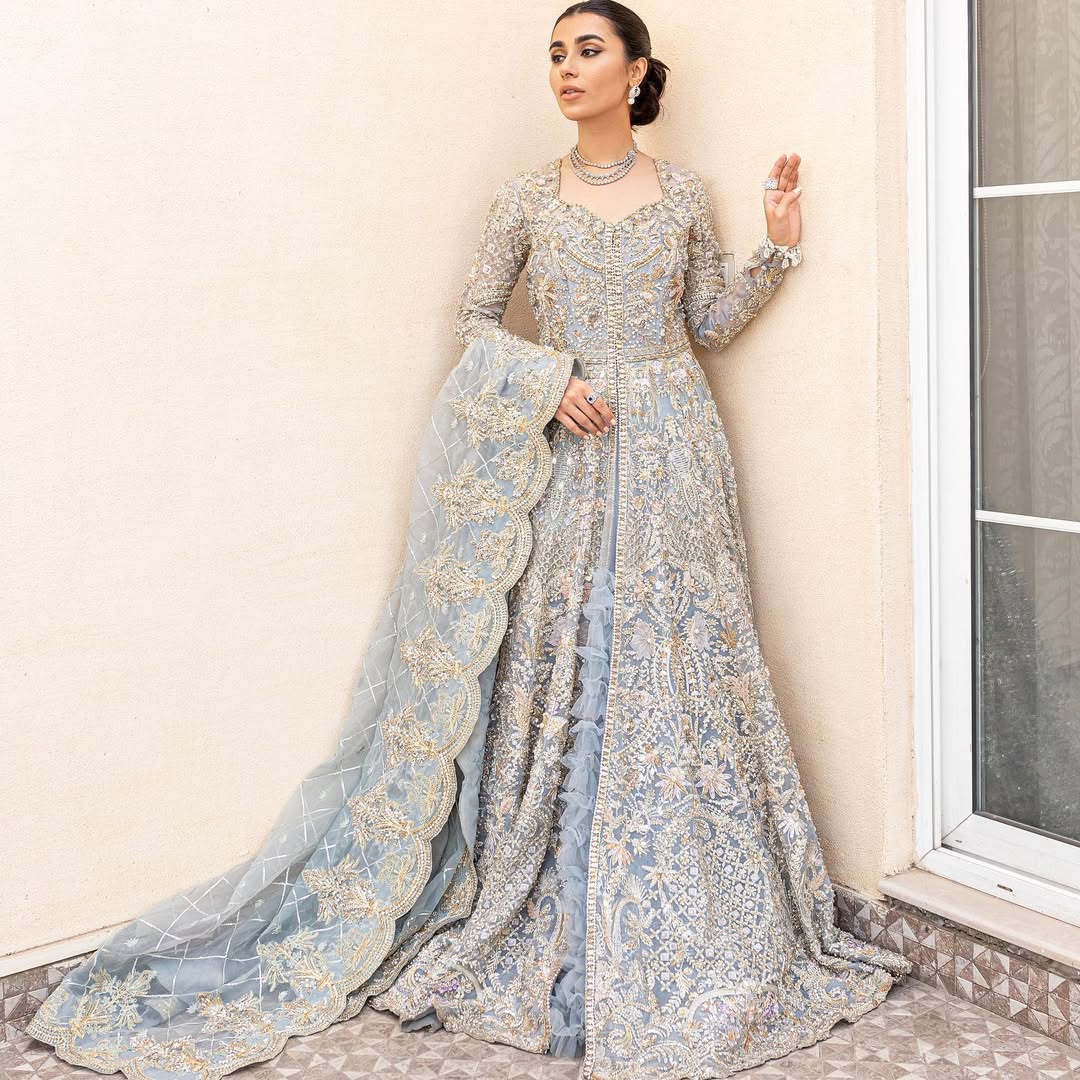 Pieta luxury Pakistani bridal outfit in ice blue organza with delicate embroidery and gold detailing.