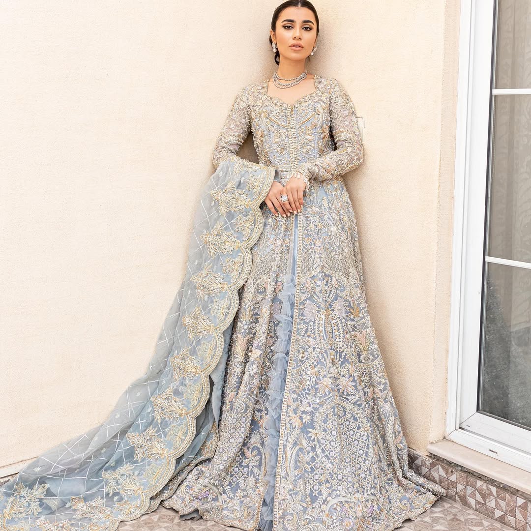 Pieta luxury Pakistani bridal outfit in ice blue organza with delicate embroidery and gold detailing.