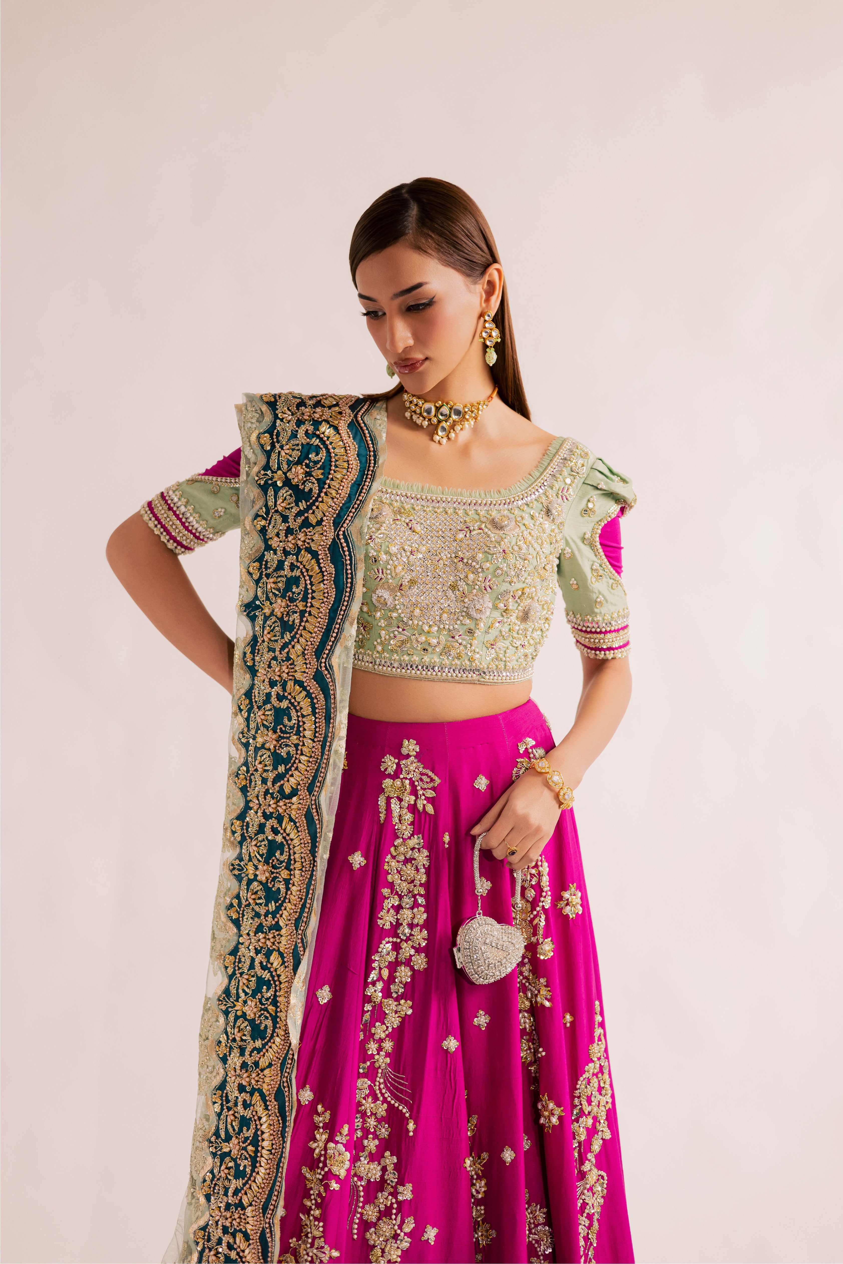 South Asian mint green bridal lehenga with pink accents by Mysie by Tahira, featuring modern hand-embellished details.