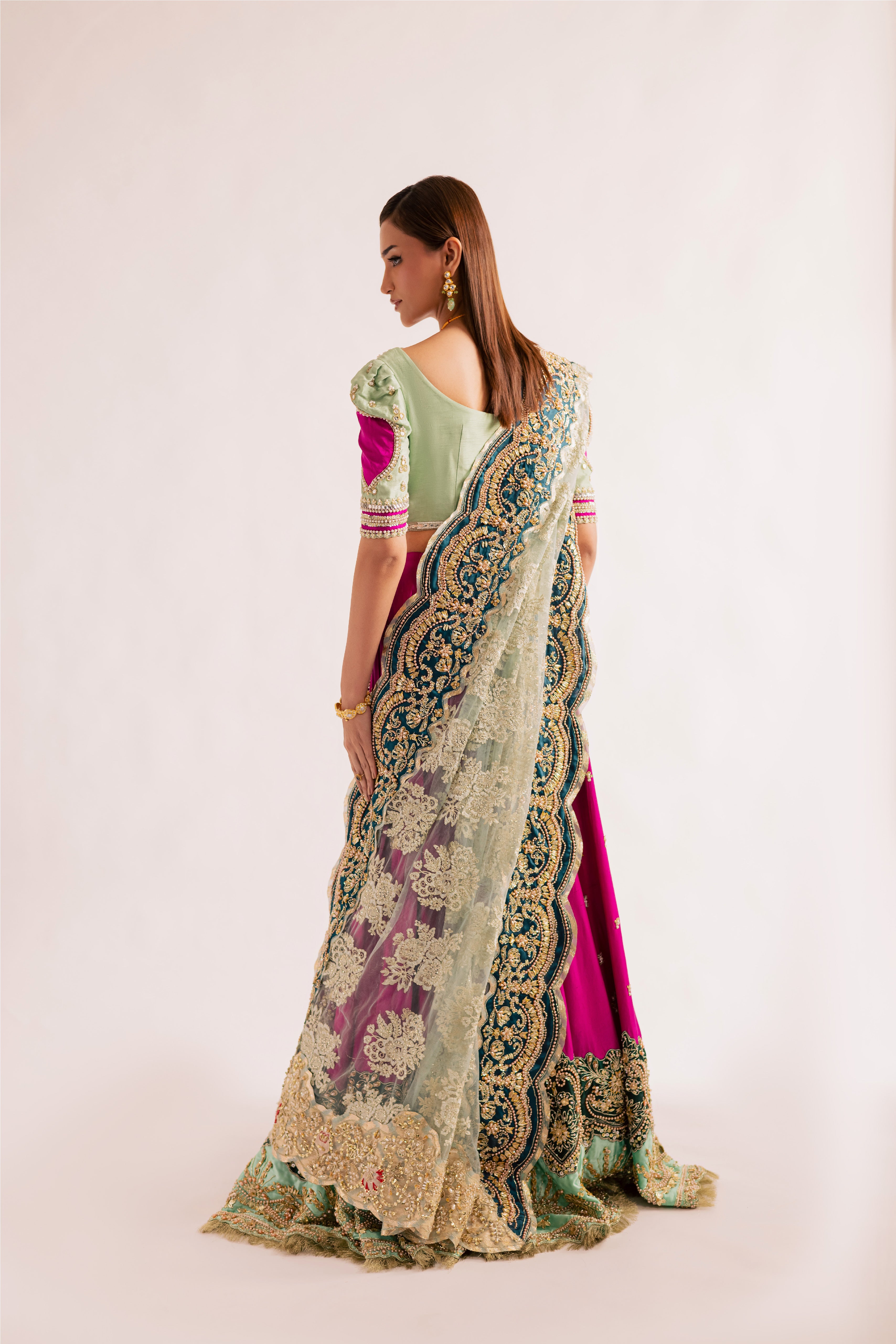 South Asian mint green bridal lehenga with pink accents by Mysie by Tahira, featuring modern hand-embellished details.