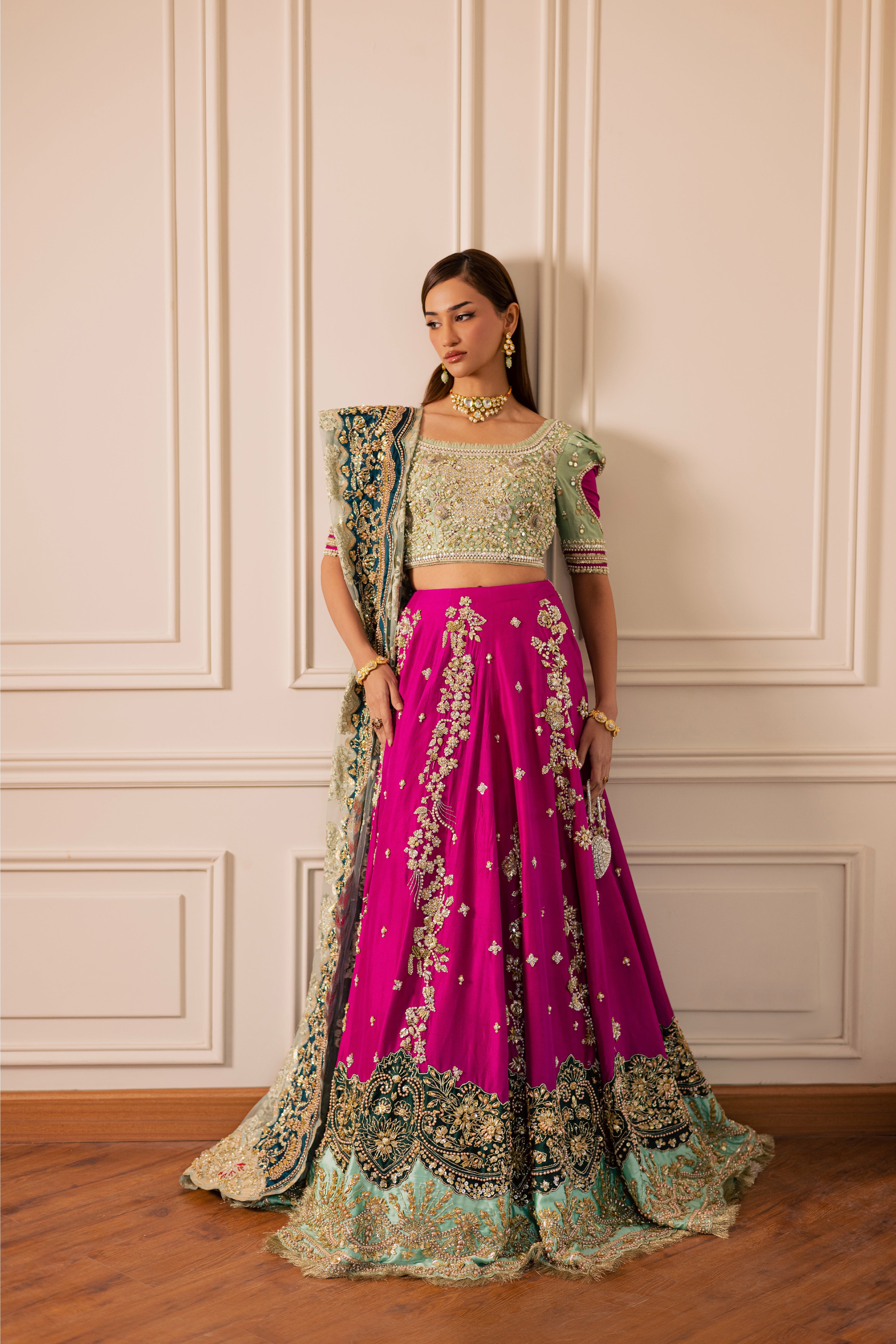 South Asian mint green bridal lehenga with pink accents by Mysie by Tahira, featuring modern hand-embellished details.