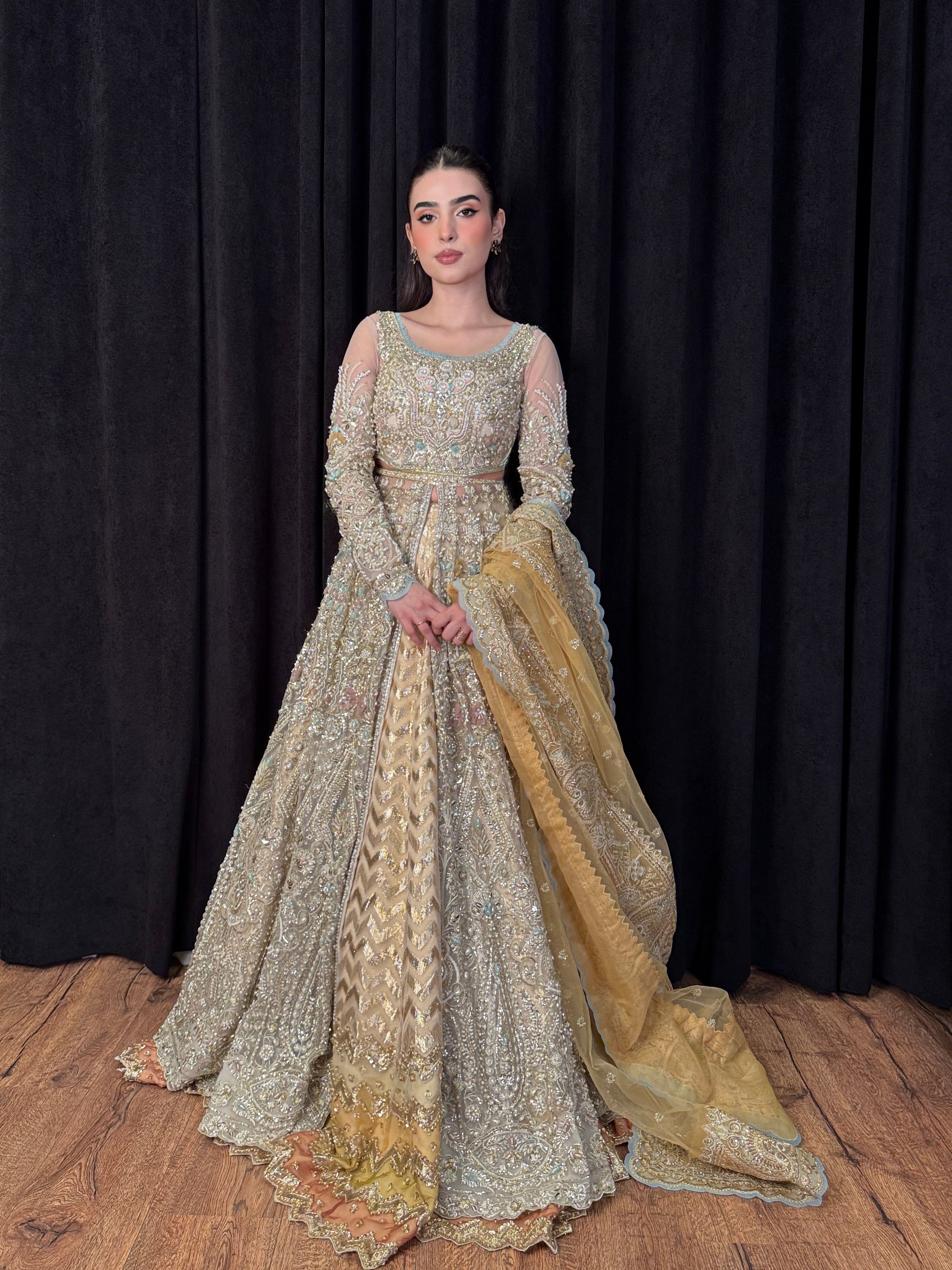 Designer champagne net gown with intricate handwork and gold dupatta – Tansa by Mysie by Tahira, Pakistani wedding wear.