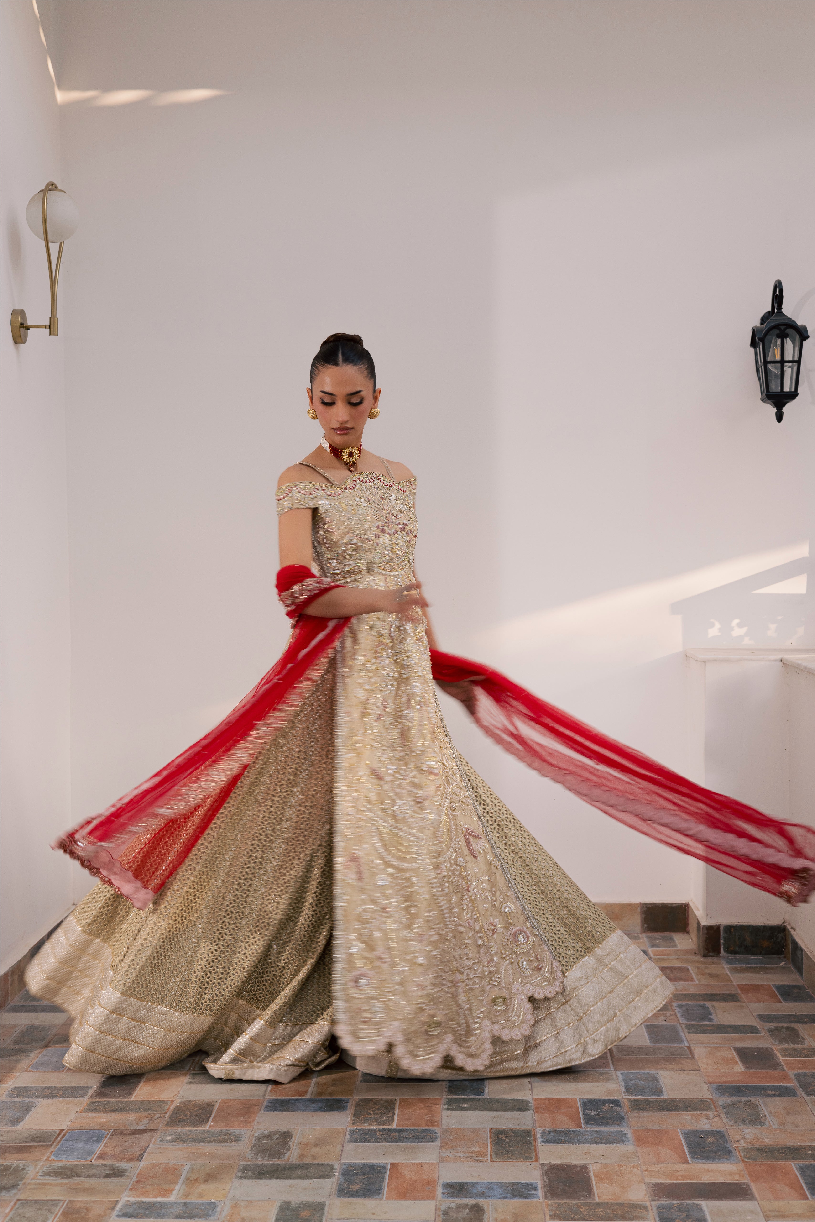 Model wearing champagne gold hand-embellished shirt and lehenga with rich maroon dupatta, luxury Pakistani couture by Mysie by Tahira.