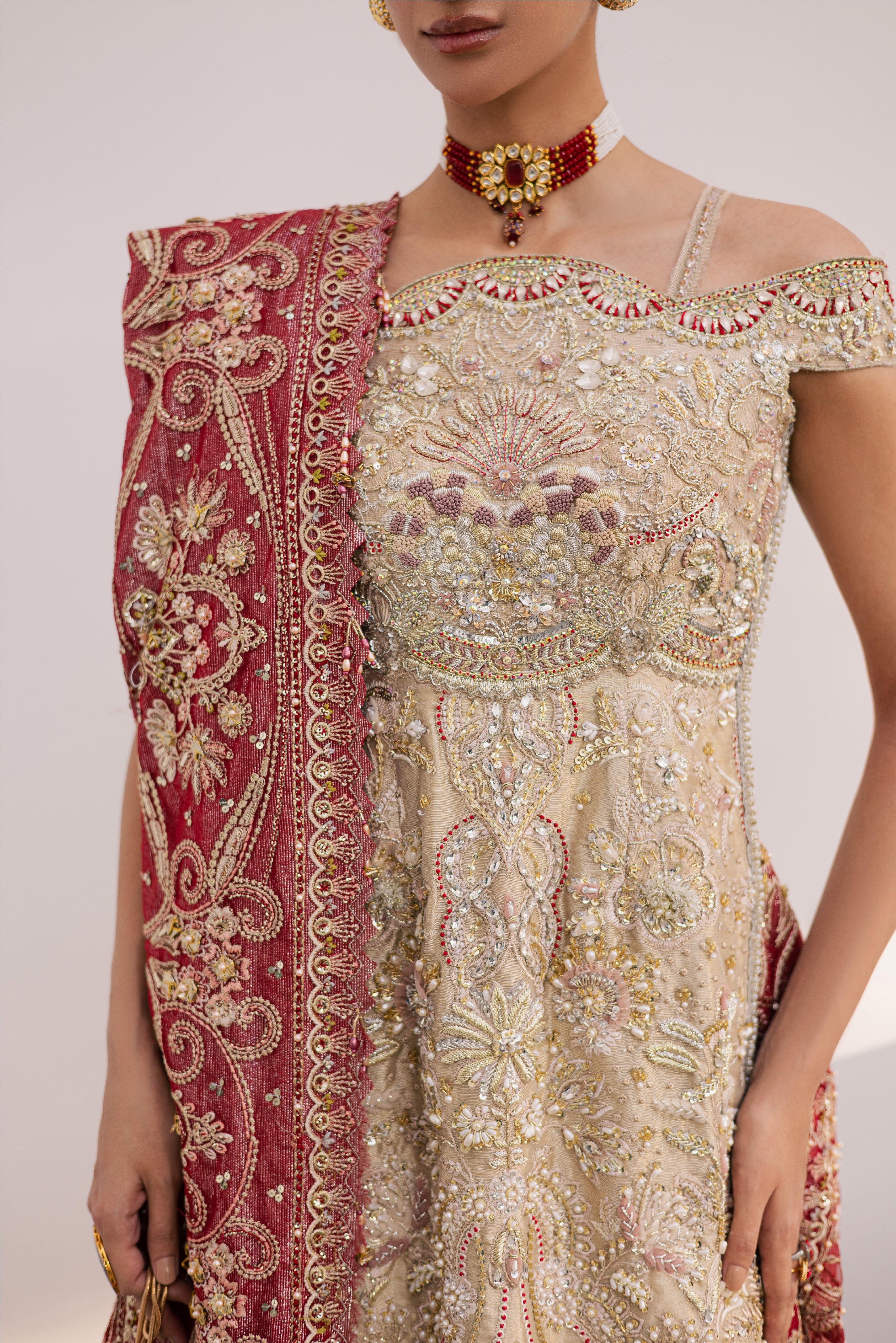 Model wearing champagne gold hand-embellished shirt and lehenga with rich maroon dupatta, luxury Pakistani couture by Mysie by Tahira.