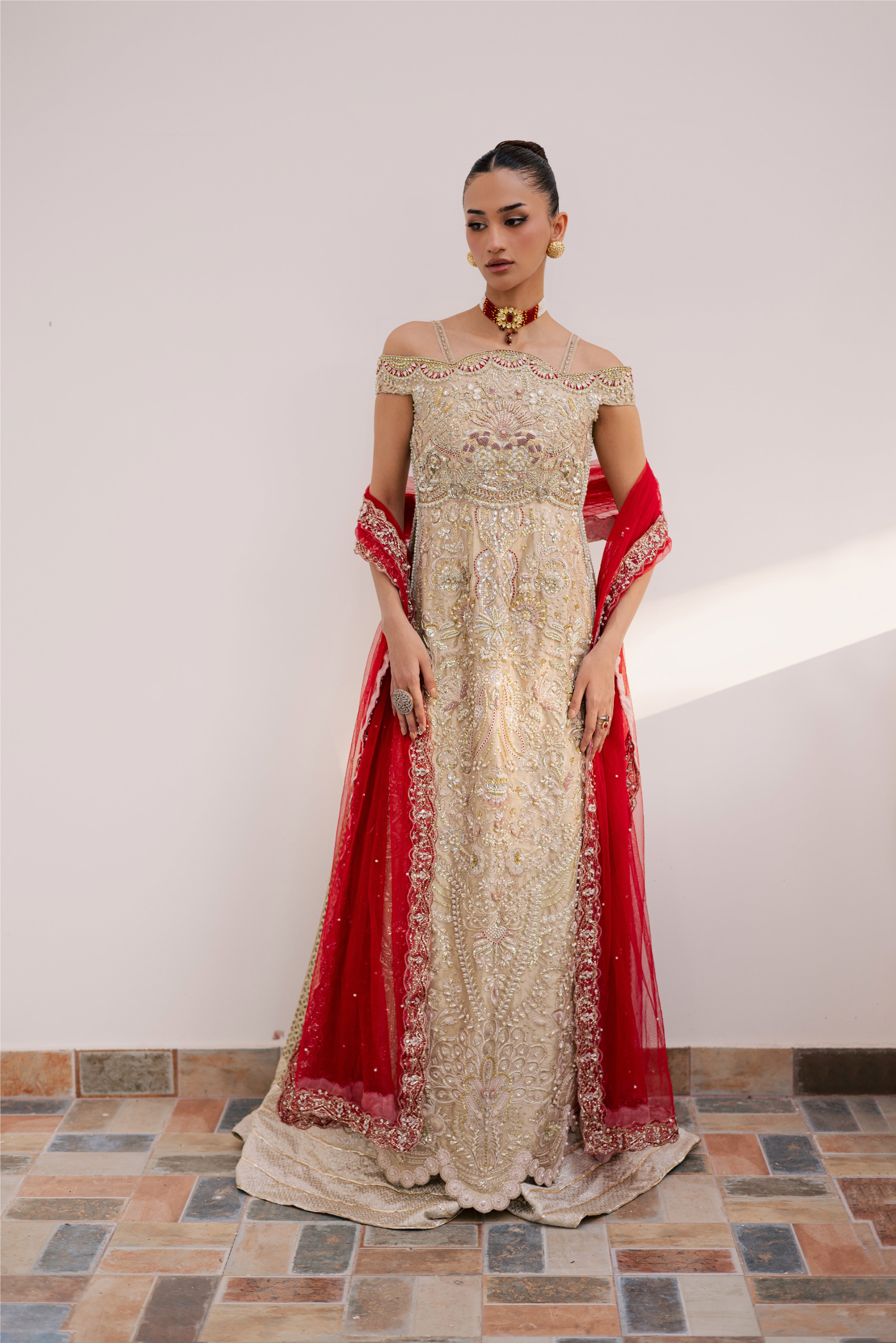 Model wearing champagne gold hand-embellished shirt and lehenga with rich maroon dupatta, luxury Pakistani couture by Mysie by Tahira.