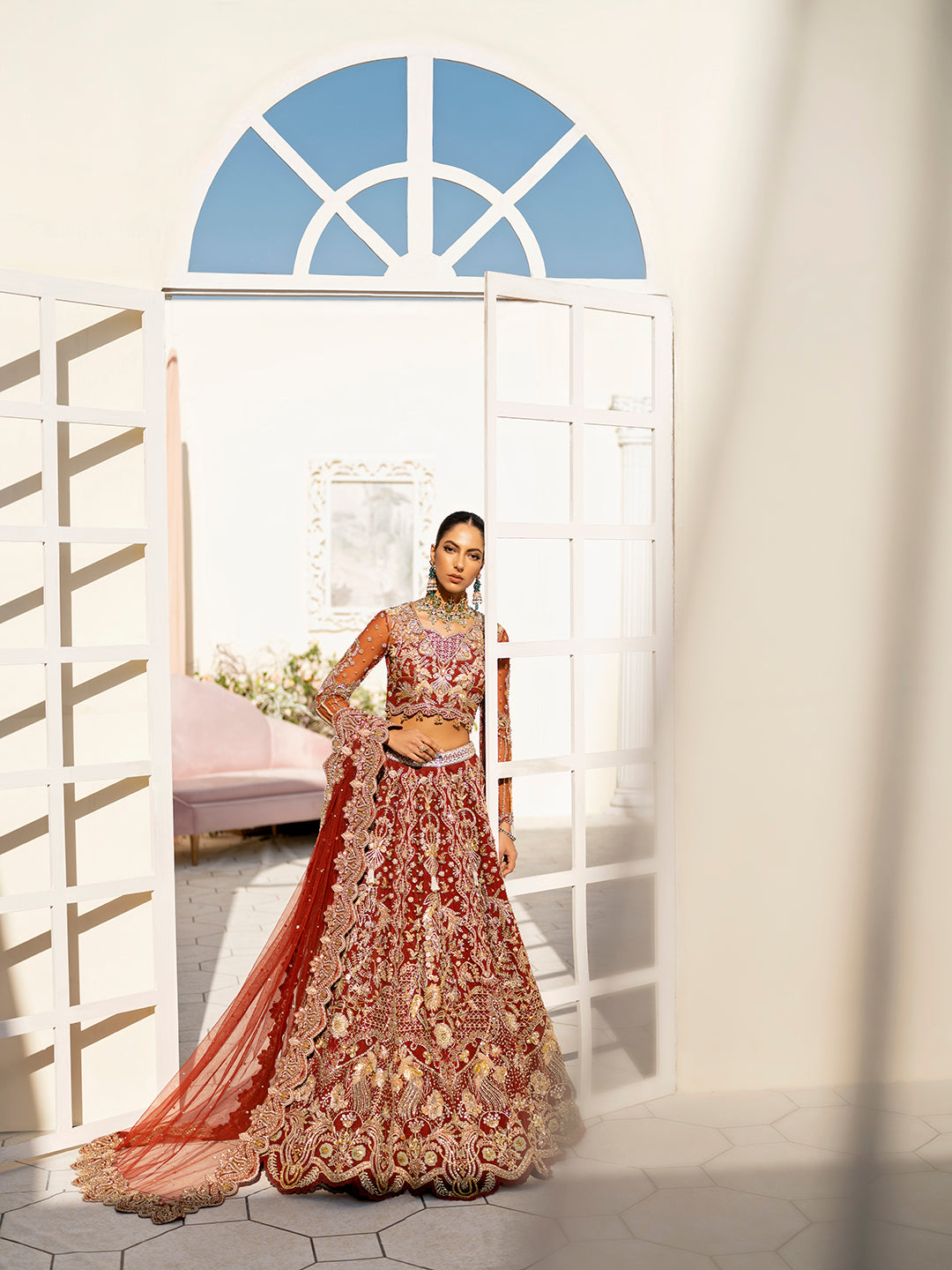 Arpieta bridal lehenga in red net with intricate gold embroidery and embellished dupatta.