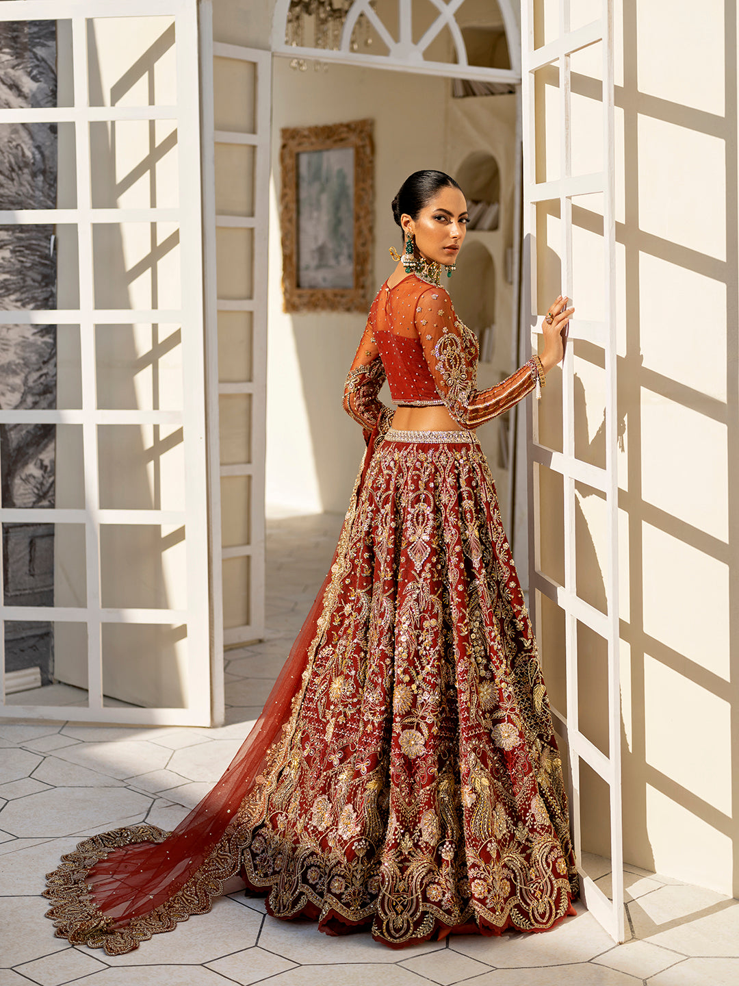 Arpieta bridal lehenga in red net with intricate gold embroidery and embellished dupatta.