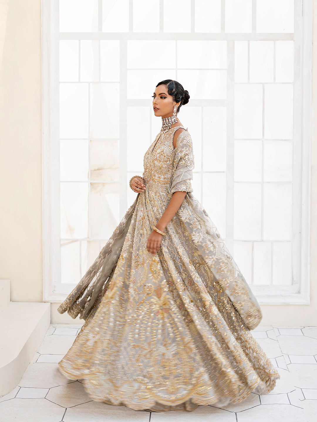 Pakistani bridal outfit Taara in ice-blue organza with gold floral embellishments.