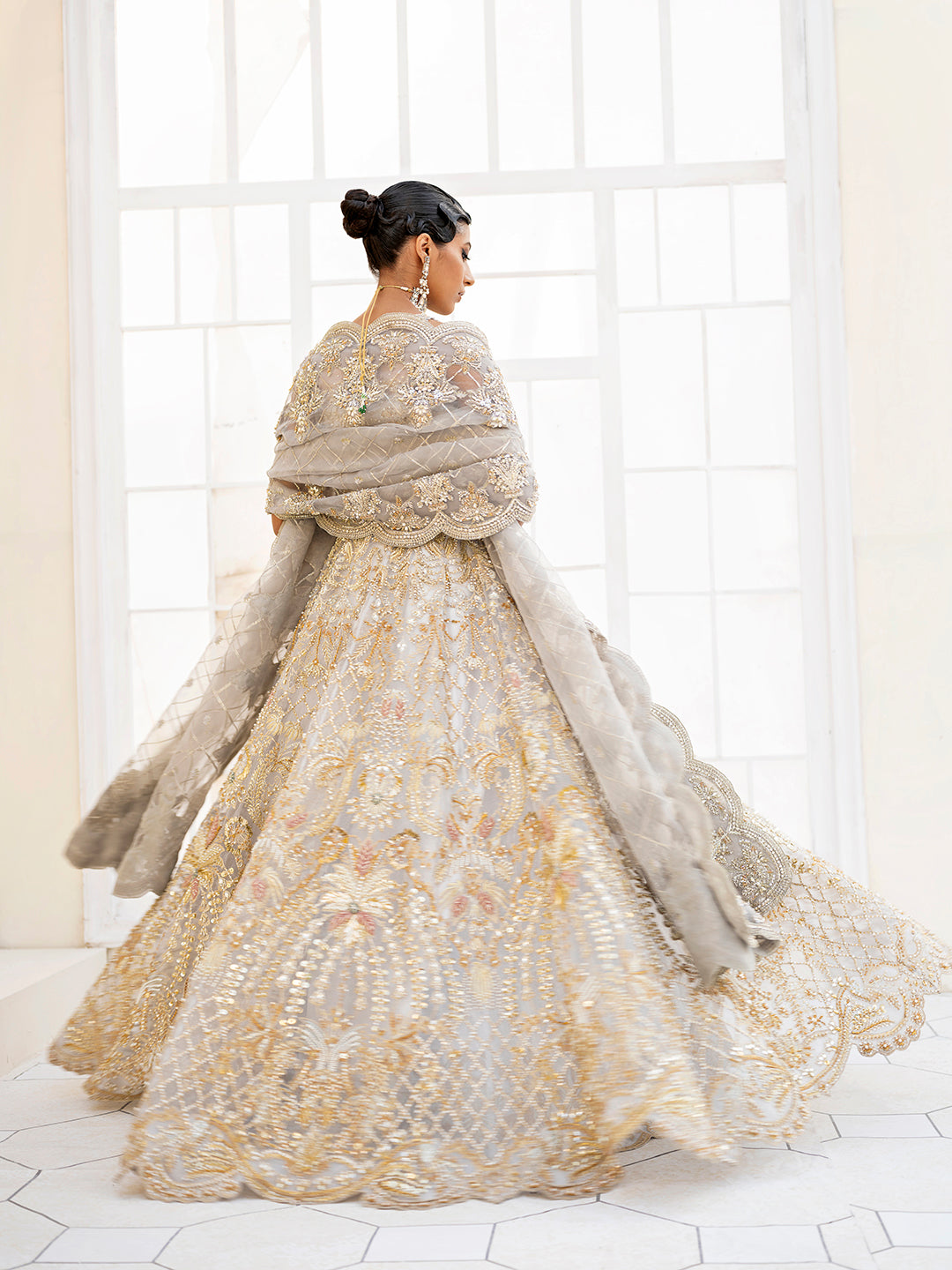 Pakistani bridal outfit Taara in ice-blue organza with gold floral embellishments.