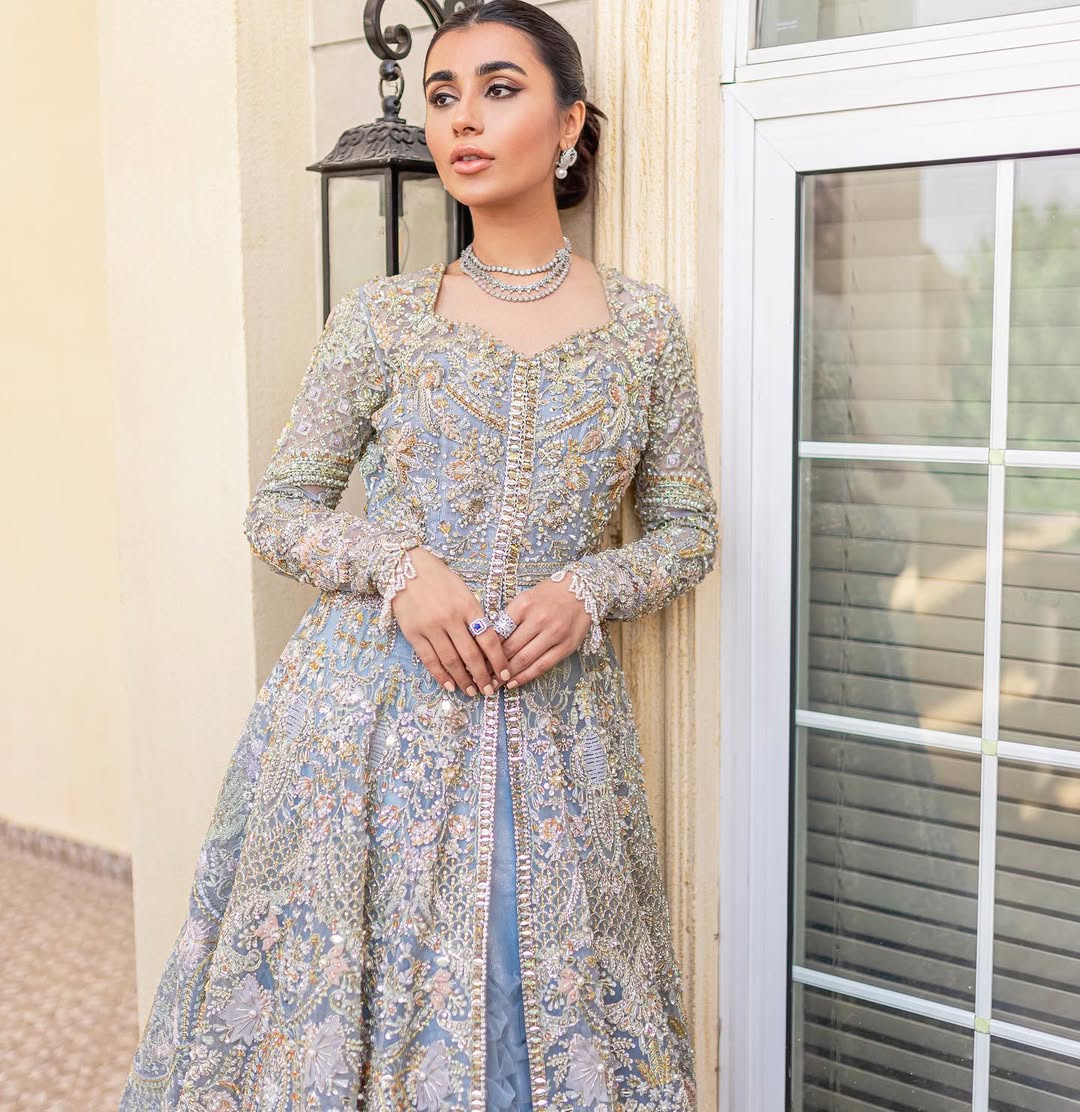 Pieta luxury Pakistani bridal outfit in ice blue organza with delicate embroidery and gold detailing.