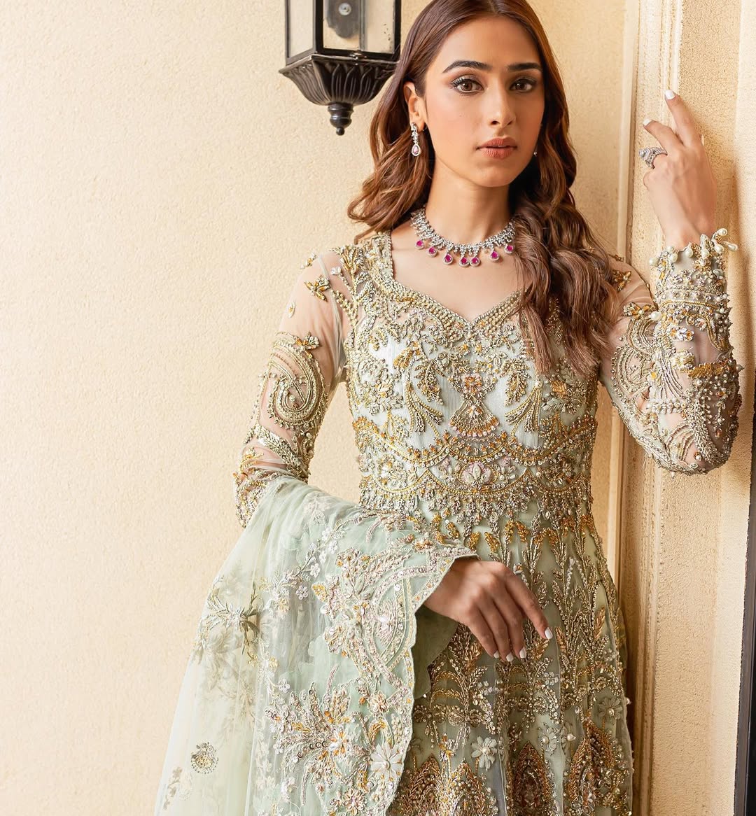 Luxury bridal ensemble Cleo in mint green with pearl embellishments on frock and raw-silk lehenga.