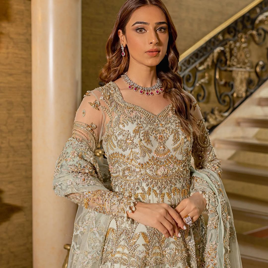 Luxury bridal ensemble Cleo in mint green with pearl embellishments on frock and raw-silk lehenga.