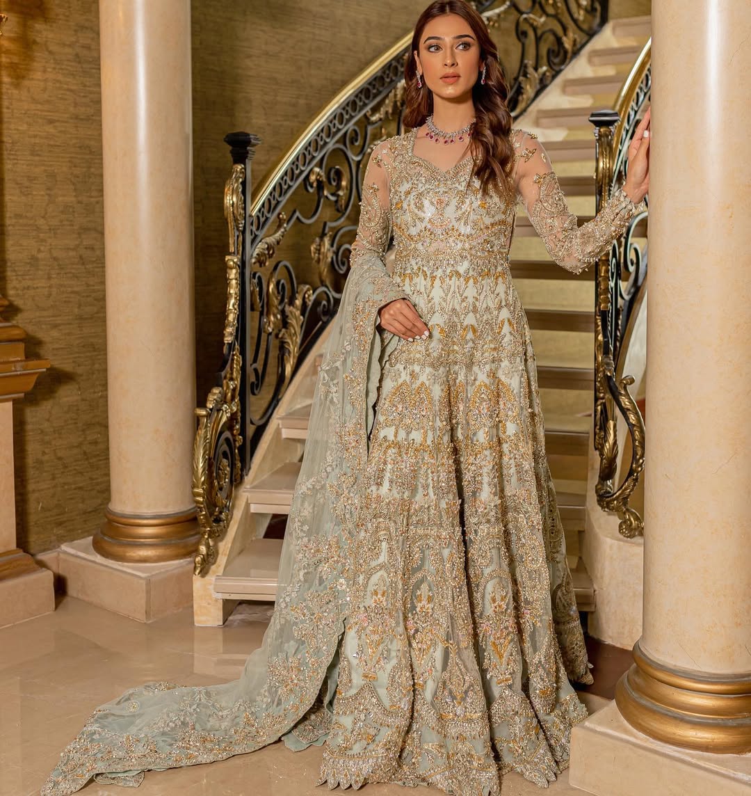 Luxury bridal ensemble Cleo in mint green with pearl embellishments on frock and raw-silk lehenga.