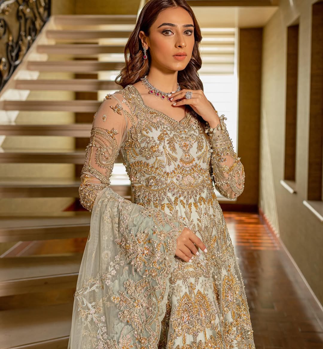 Luxury bridal ensemble Cleo in mint green with pearl embellishments on frock and raw-silk lehenga.