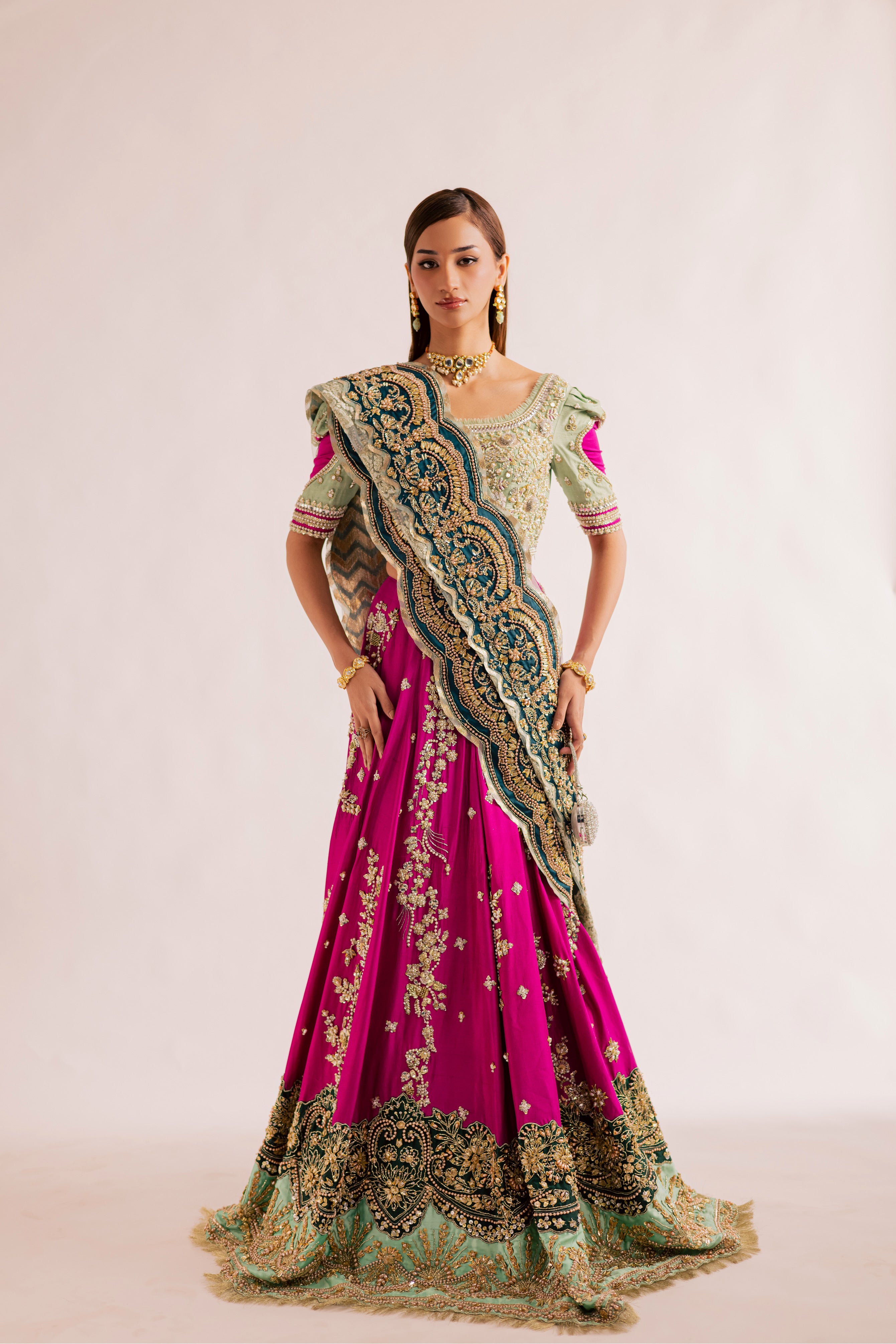 South Asian mint green bridal lehenga with pink accents by Mysie by Tahira, featuring modern hand-embellished details.
