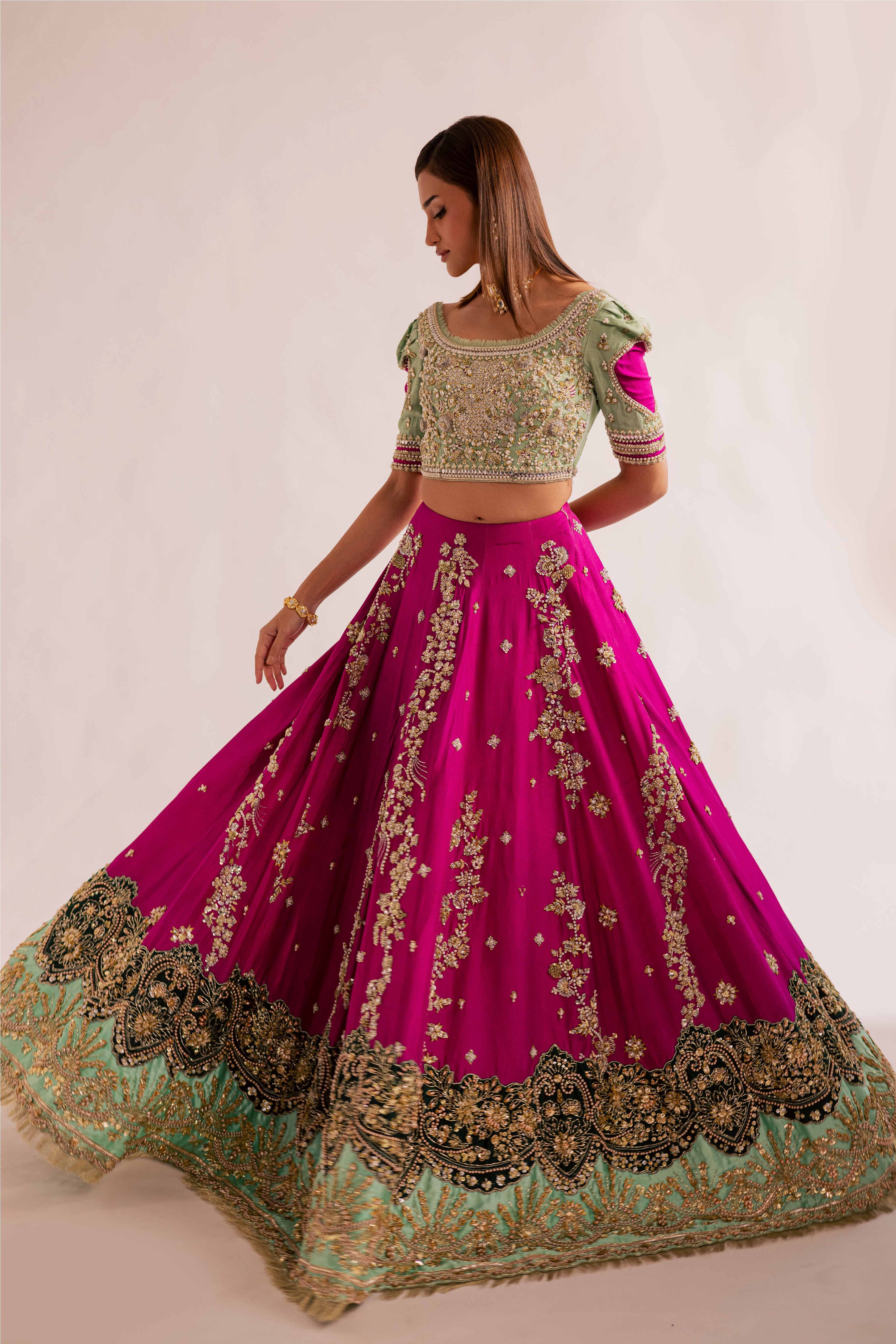 South Asian mint green bridal lehenga with pink accents by Mysie by Tahira, featuring modern hand-embellished details.