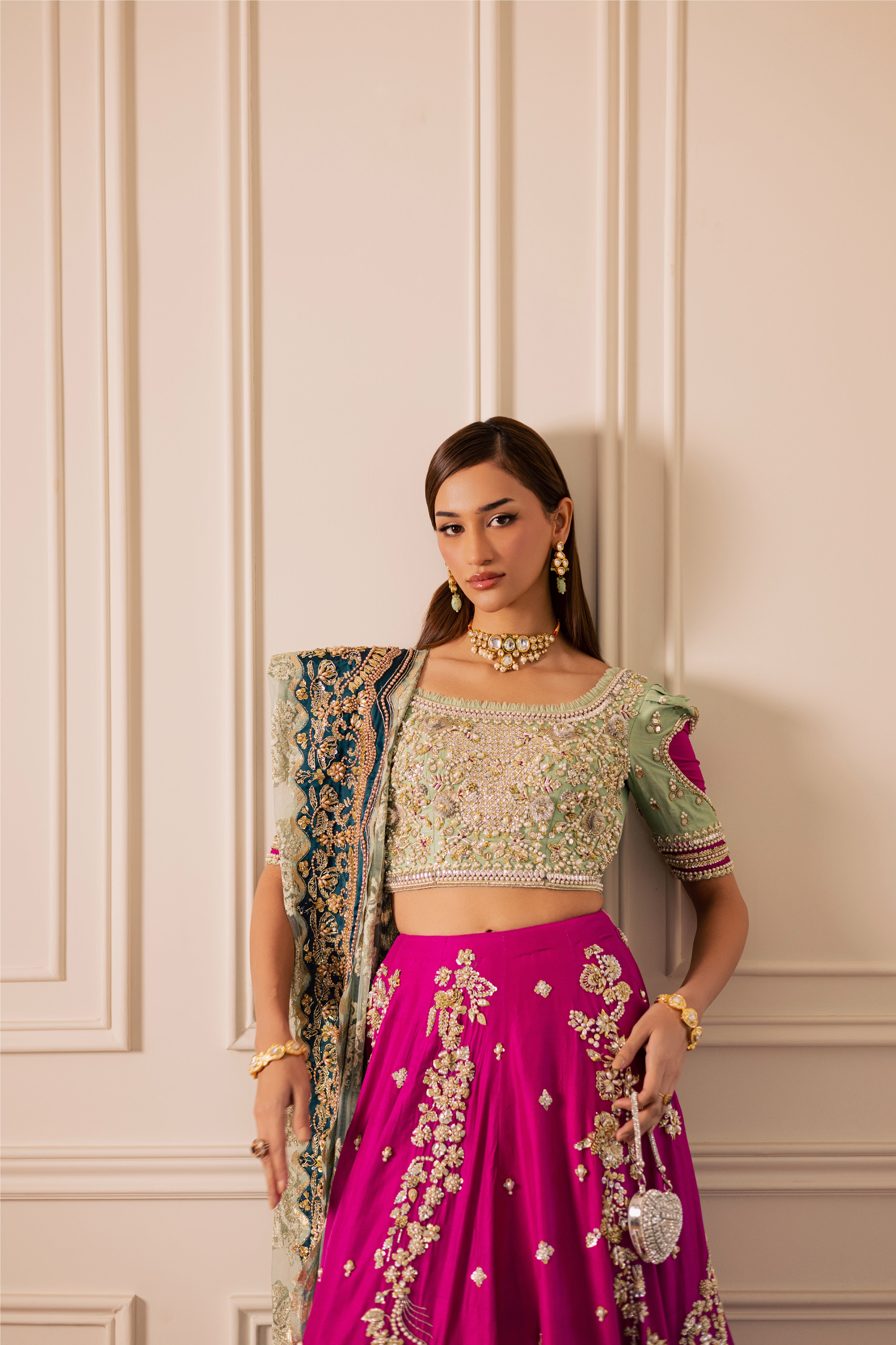 South Asian mint green bridal lehenga with pink accents by Mysie by Tahira, featuring modern hand-embellished details.