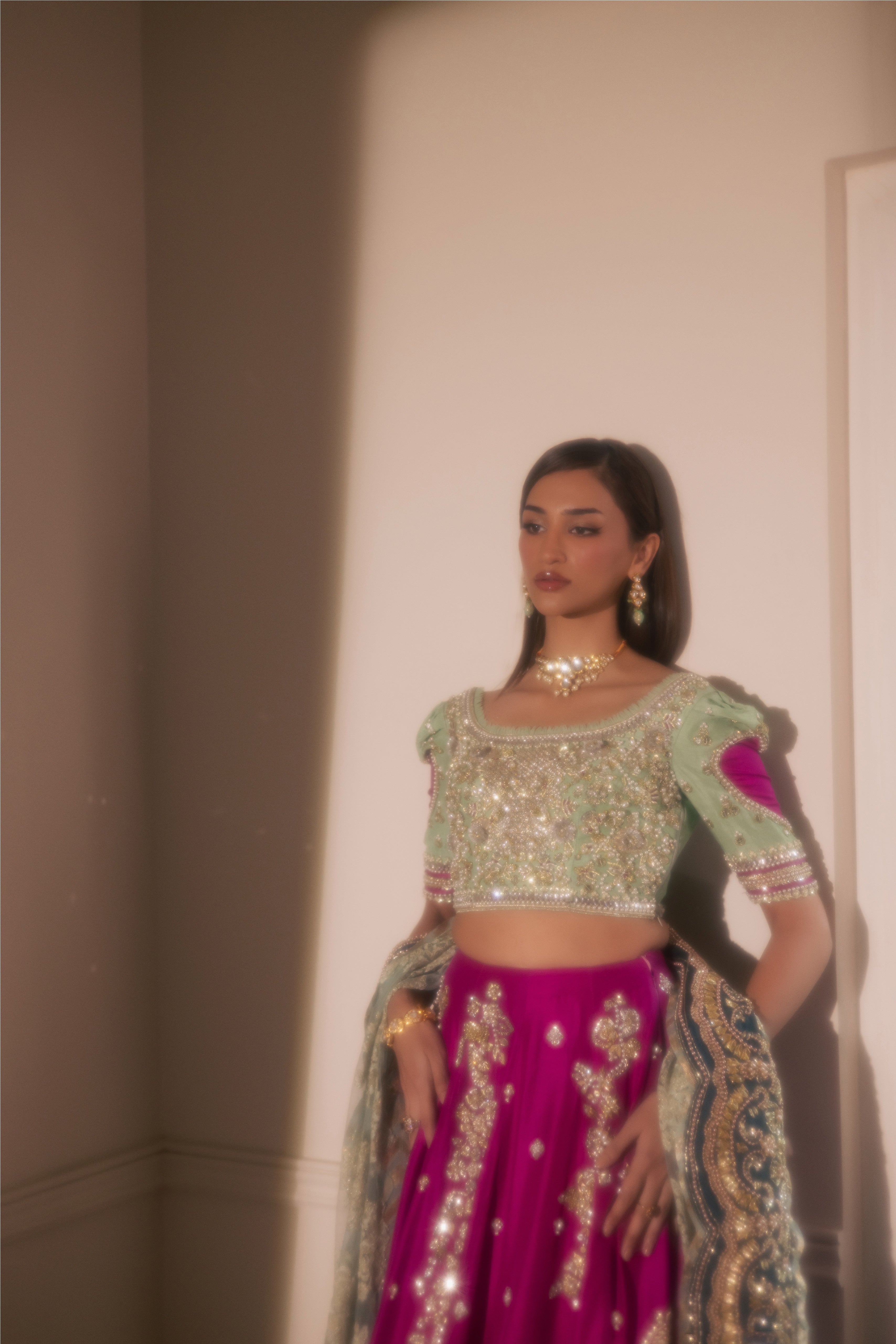South Asian mint green bridal lehenga with pink accents by Mysie by Tahira, featuring modern hand-embellished details.