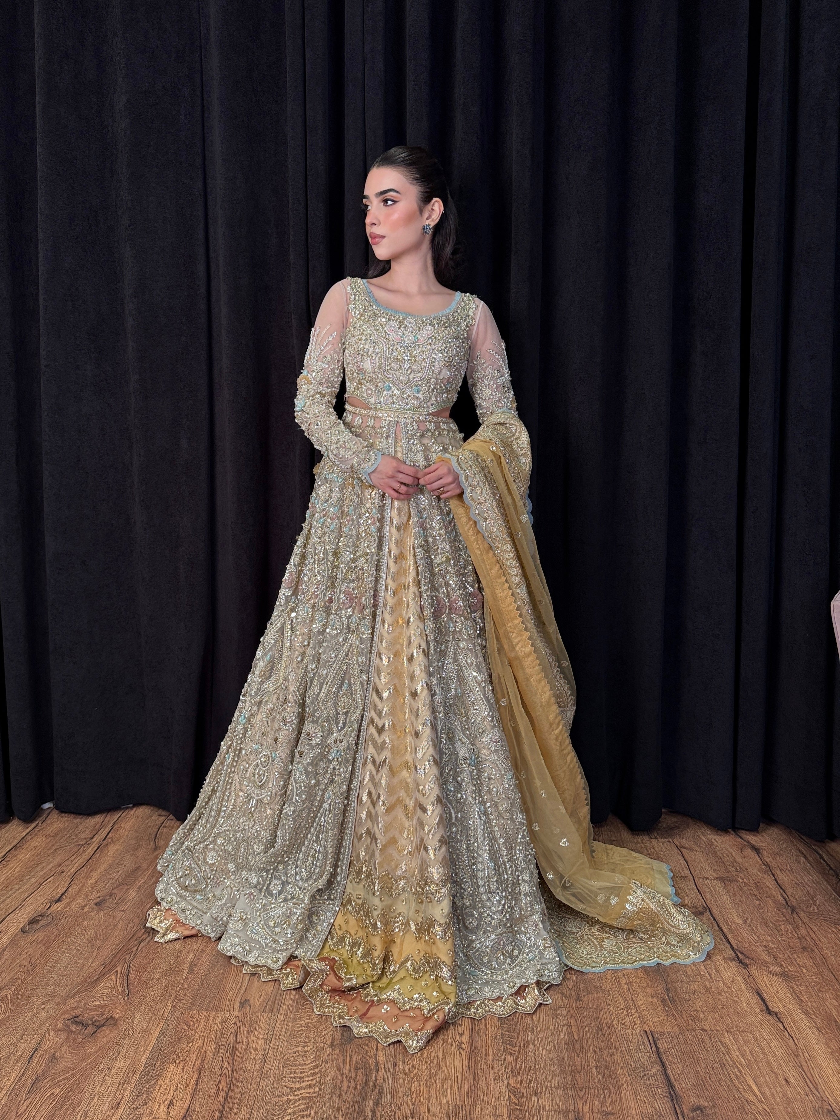 Designer champagne net gown with intricate handwork and gold dupatta – Tansa by Mysie by Tahira, Pakistani wedding wear.