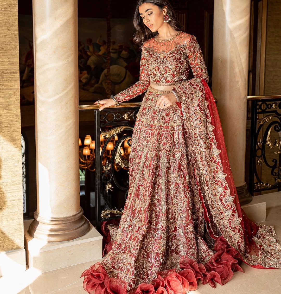 Luxury bridal lehnga choli in deep red with gold details by Mysie by Tahira