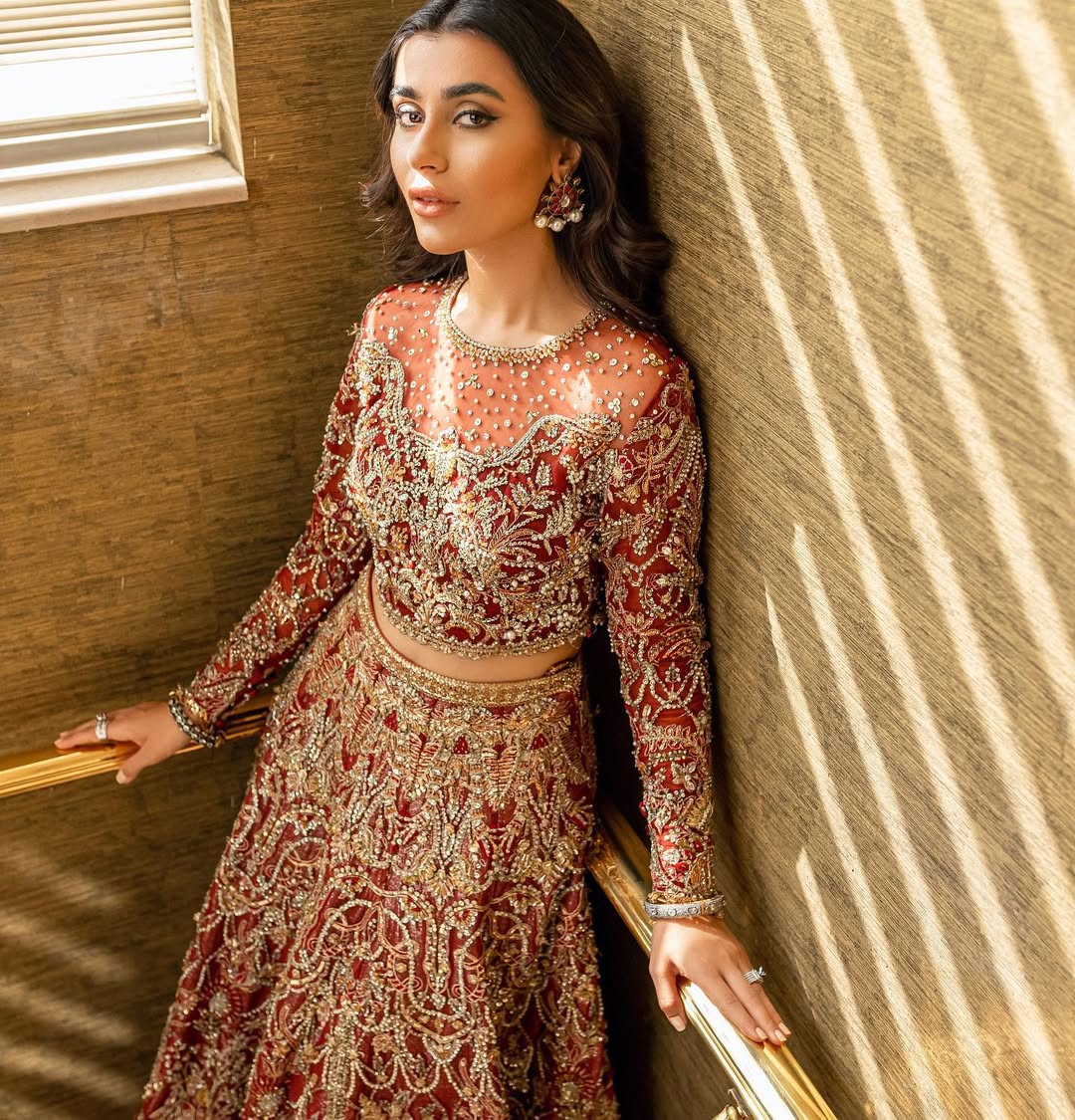 Luxury bridal lehnga choli in deep red with gold details by Mysie by Tahira
