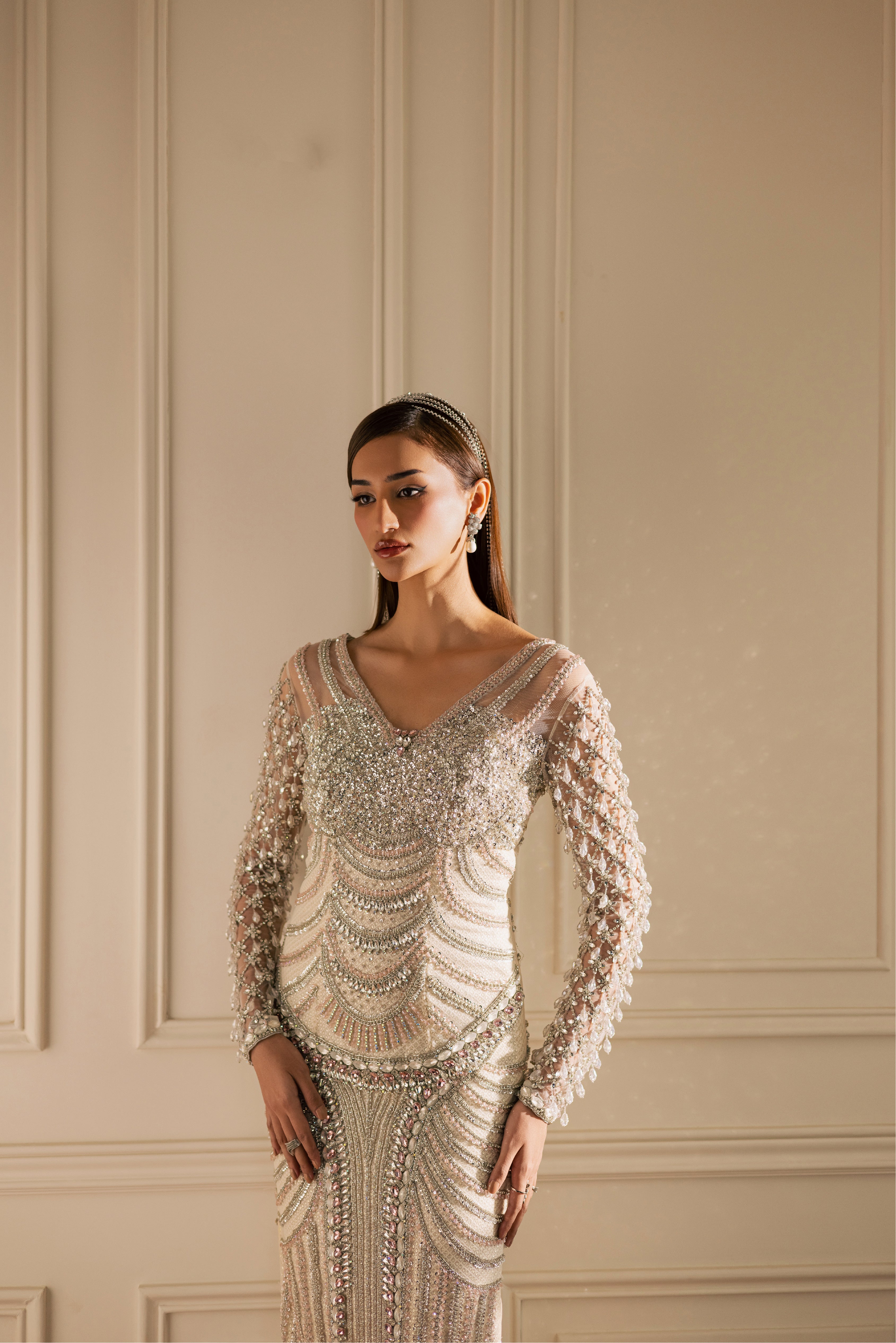 Hand-embellished Opal pearl-white luxury evening gown with sheer sleeves and crystals by Mysie By Tahira.