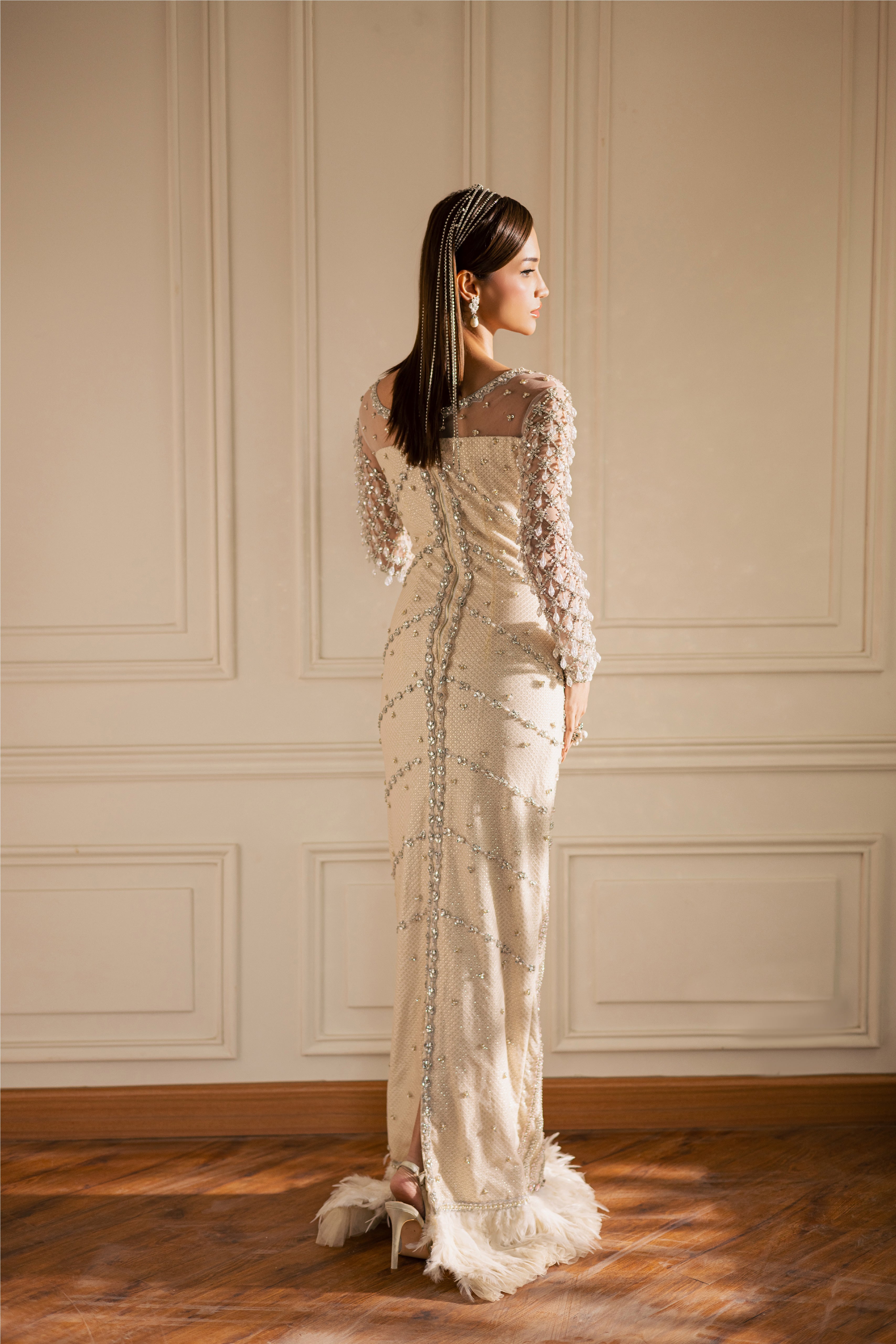 Hand-embellished Opal pearl-white luxury evening gown with sheer sleeves and crystals by Mysie By Tahira.
