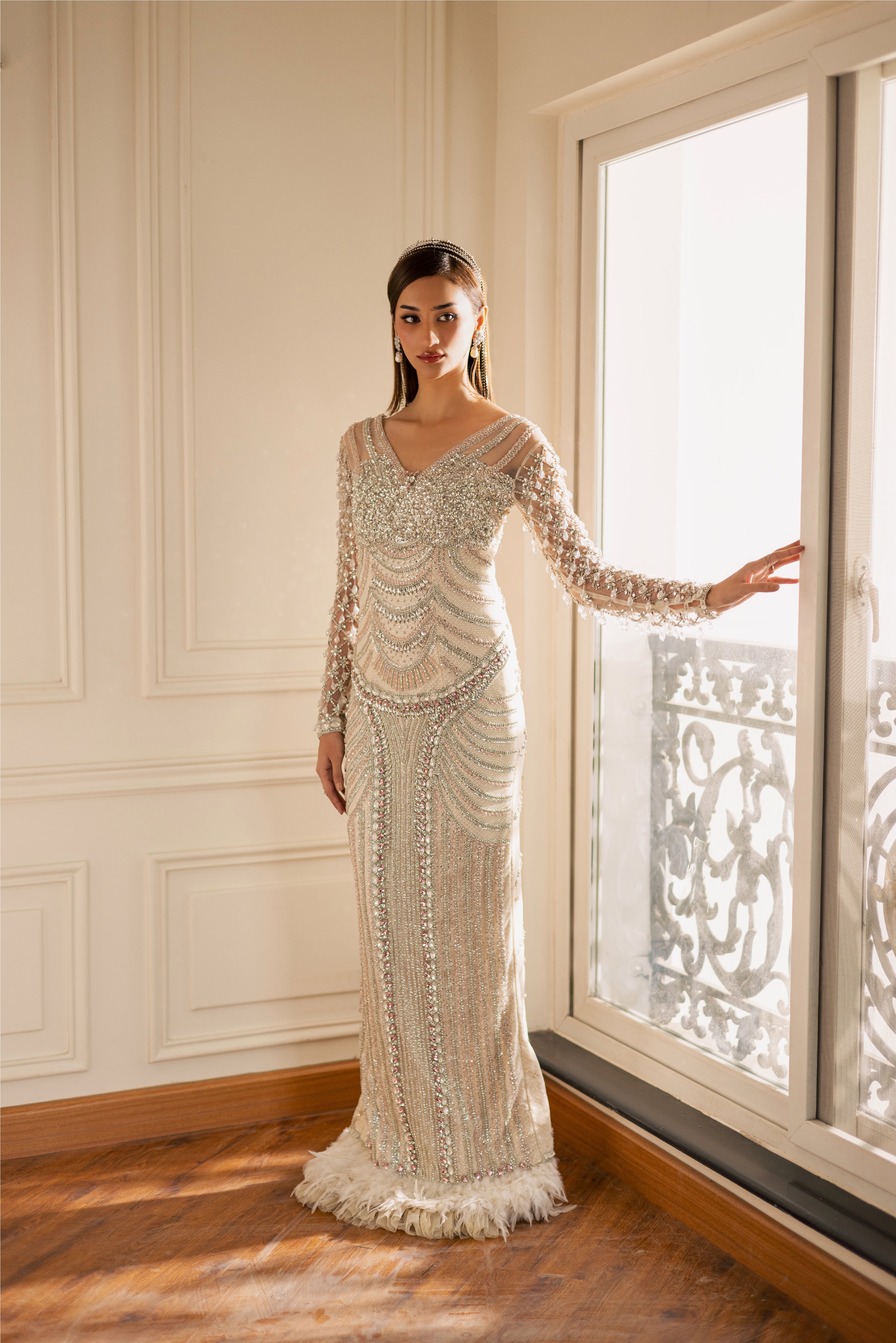 Hand-embellished Opal pearl-white luxury evening gown with sheer sleeves and crystals by Mysie By Tahira.