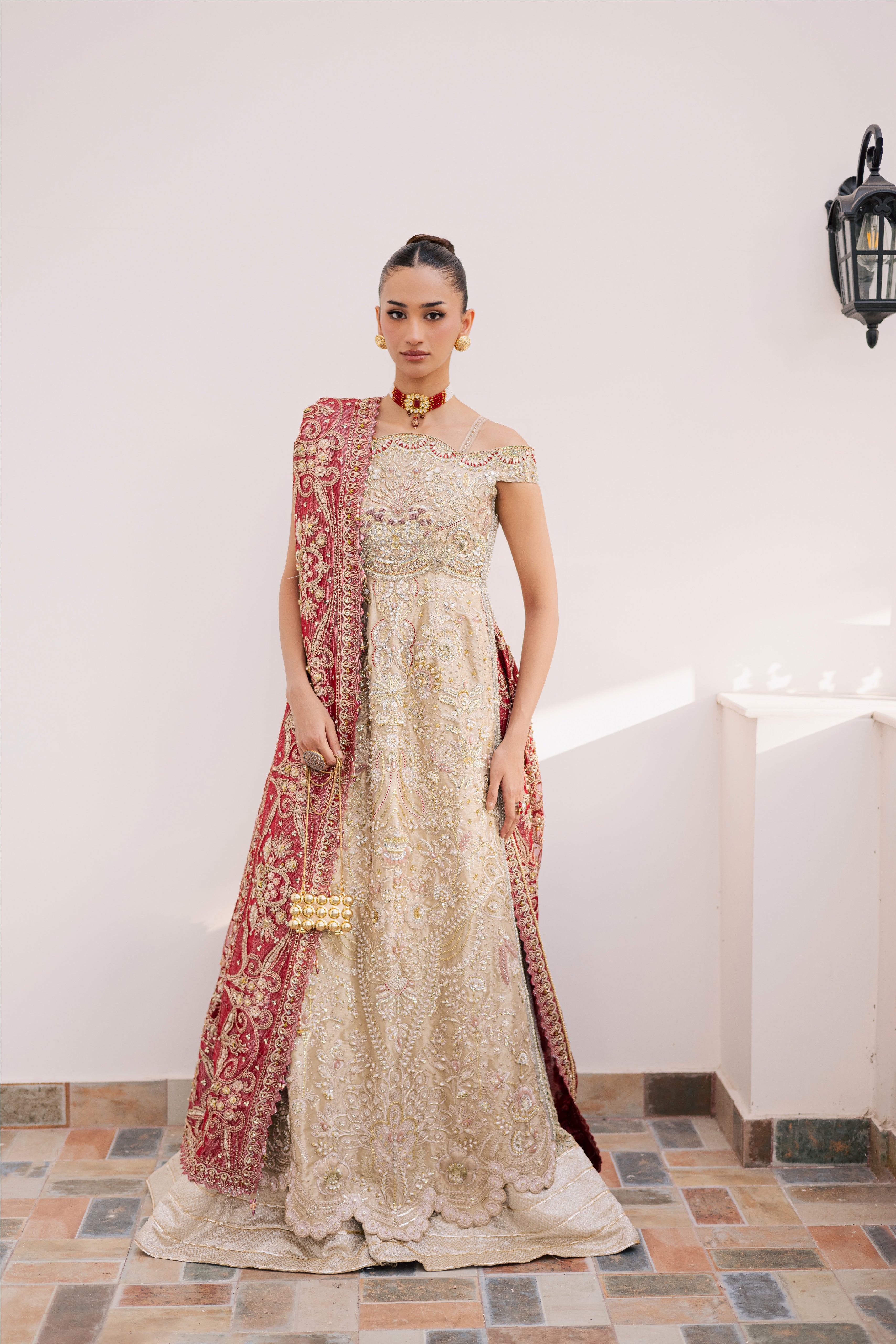Model wearing champagne gold hand-embellished shirt and lehenga with rich maroon dupatta, luxury Pakistani couture by Mysie by Tahira.