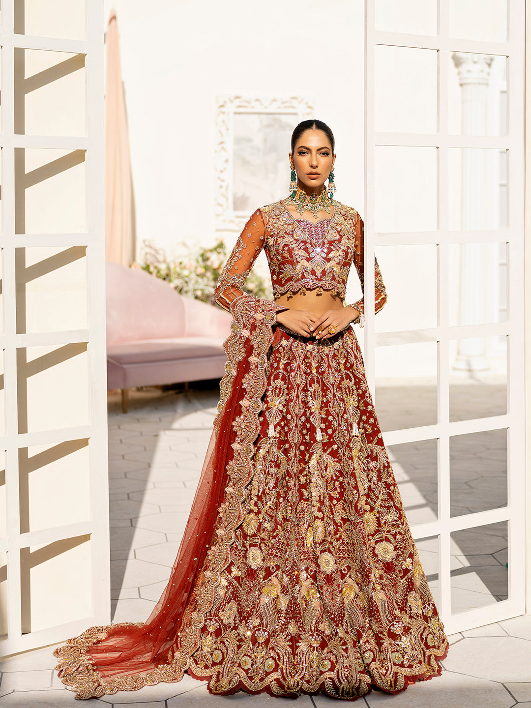 Arpieta bridal lehenga in red net with intricate gold embroidery and embellished dupatta.
