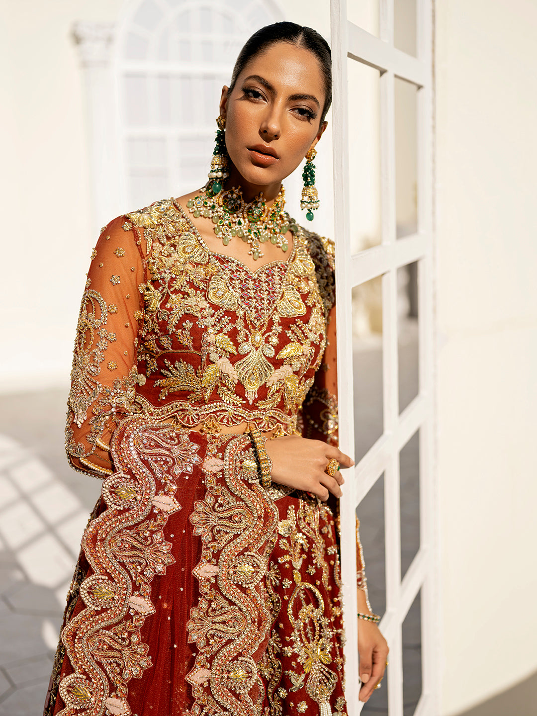 Arpieta bridal lehenga in red net with intricate gold embroidery and embellished dupatta.