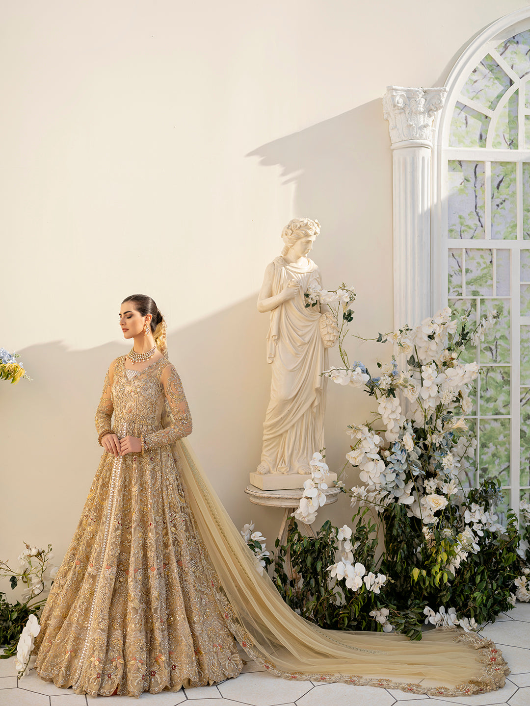 Mahjabeen Pakistani gold bridal gown with hand embroidery and embellished dupatta.