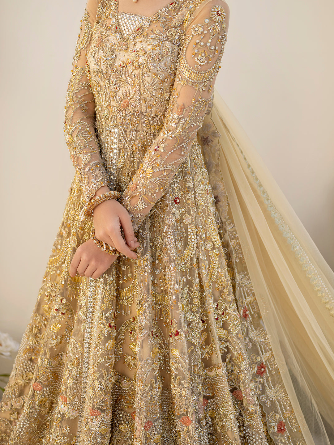 Mahjabeen Pakistani gold bridal gown with hand embroidery and embellished dupatta.