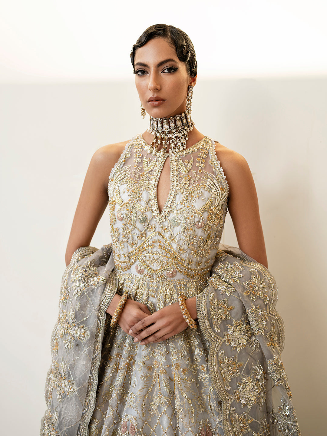 Pakistani bridal outfit Taara in ice-blue organza with gold floral embellishments.