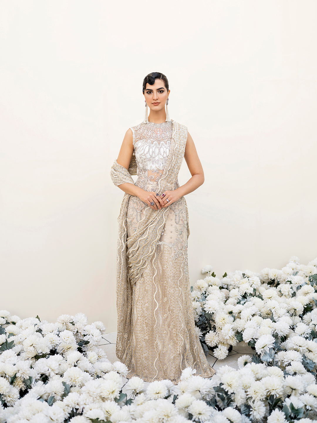 Pakistani luxury formal saree Malaikah in white and gold net fabric with intricate embellishments.