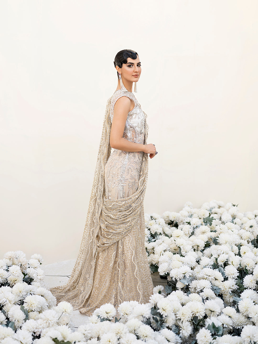 Pakistani luxury formal saree Malaikah in white and gold net fabric with intricate embellishments.
