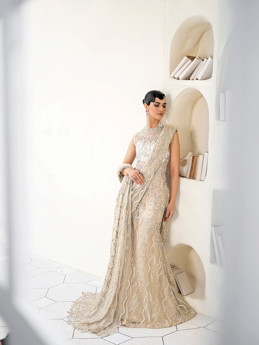 Pakistani luxury formal saree Malaikah in white and gold net fabric with intricate embellishments.