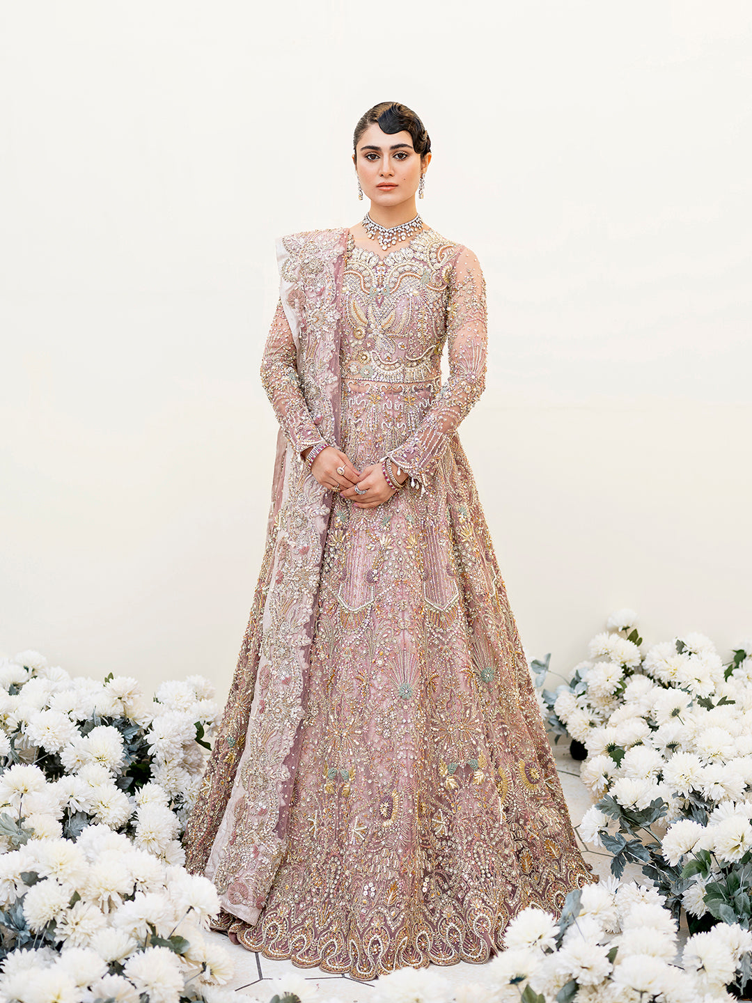 Sereena Pakistani bridal peshwas in lilac net with ice blue and gold embellishments.
