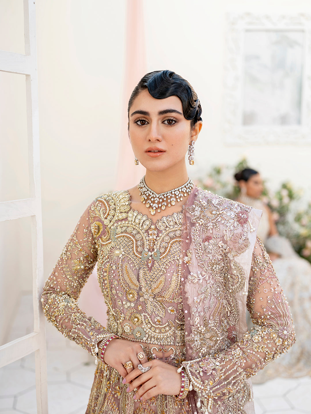 Sereena Pakistani bridal peshwas in lilac net with ice blue and gold embellishments.