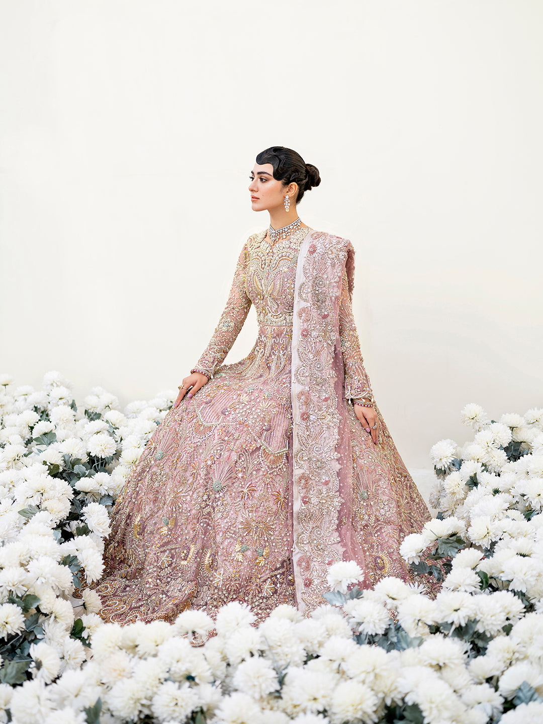 Sereena Pakistani bridal peshwas in lilac net with ice blue and gold embellishments.